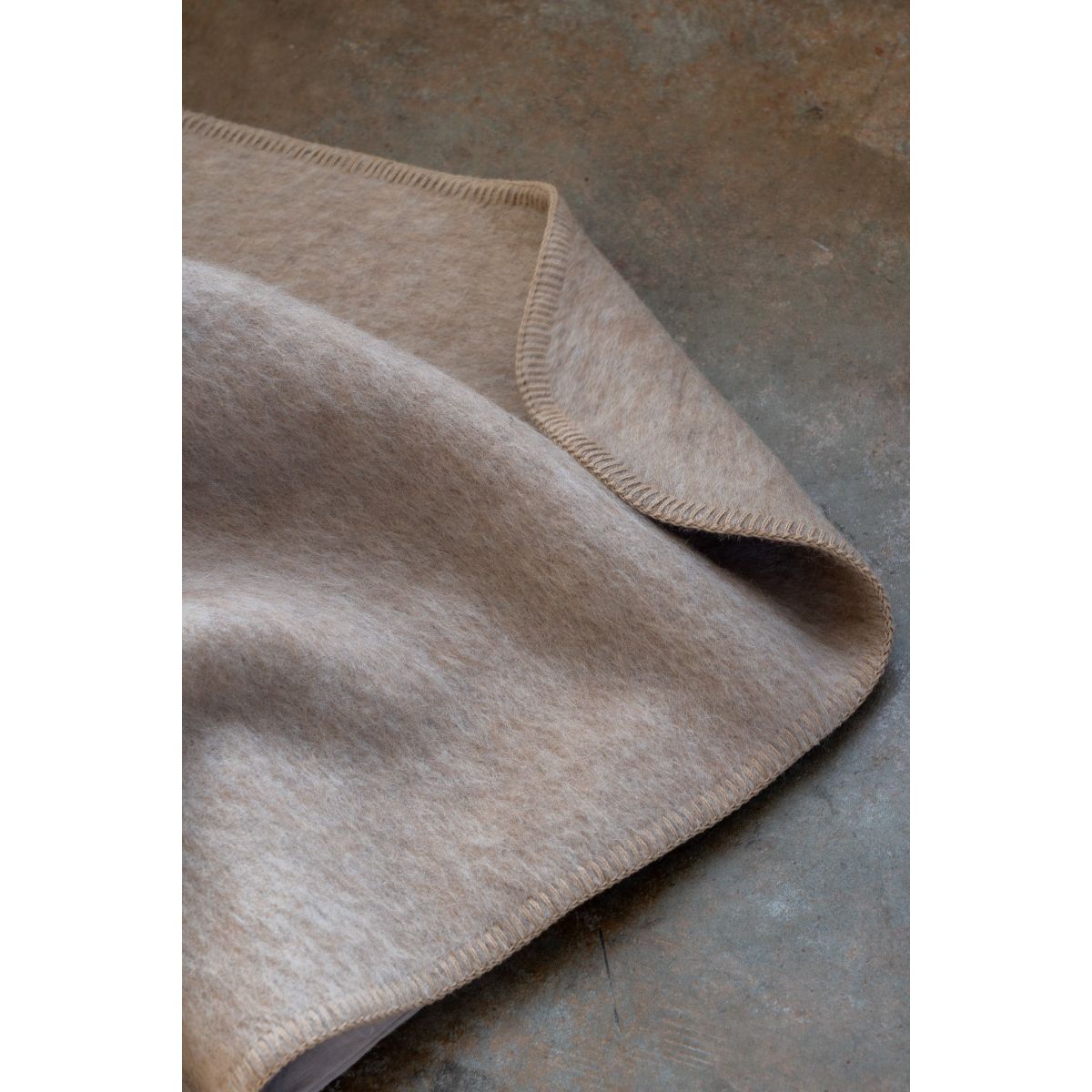 Beige blanket on a textured surface