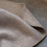 Beige blanket on a textured surface