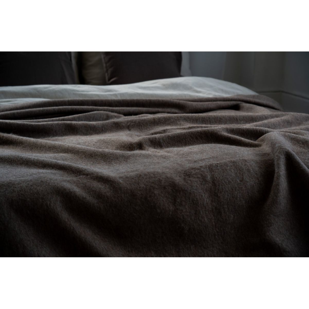 Brown textured blanket on a surface with a neutral background