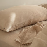 Nude pillow and bedding on a bed with a neutral background